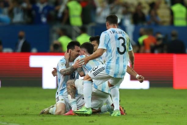 Lionel Messi of Argentina celebrates with teammates Rodrigo De Paul and Nicolas Tagliafico after winning during the final of Copa America Brazil 2021...