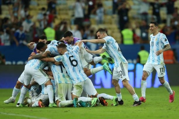 Giovani Lo Celso, German Pezzella and Angel Di Maria of Argentina jump to celebrate with their captain Lionel Messi after winning the final of Copa...