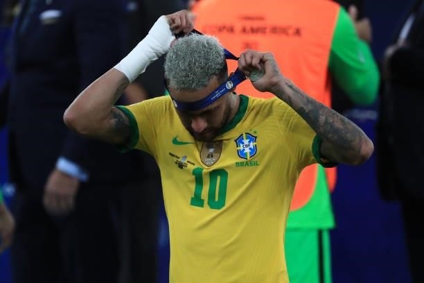Neymar Jr. Of Brazil takes off his second place medal after the final of Copa America Brazil 2021 between Brazil and Argentina at Maracana Stadium on...