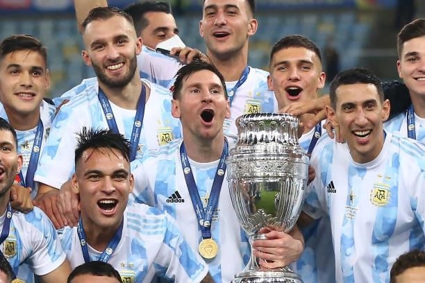 Lionel Messi of Argentina holds the trophy with teammates after winning the final of Copa America Brazil 2021 between Brazil and Argentina at...