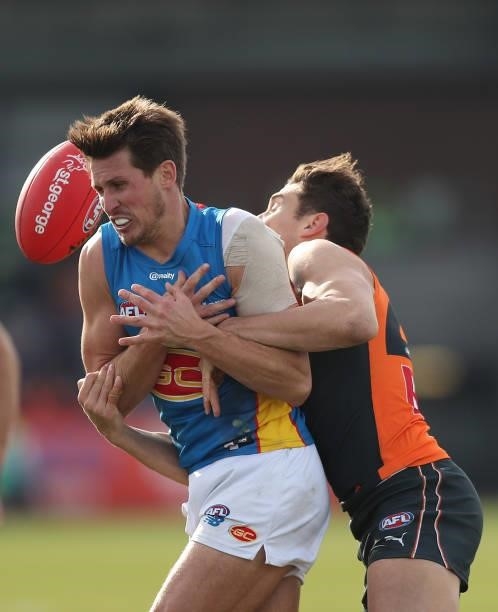 David Swallow of the Suns is tackled during the round 17 AFL match between Greater Western Sydney Giants and Gold Coast Suns at Mars Stadium on July...