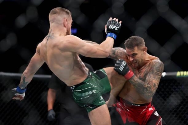 Conor McGregor of Ireland lands a knee on Dustin Poirier in the first round in their lightweight bout during UFC 264: Poirier v McGregor 3 at...