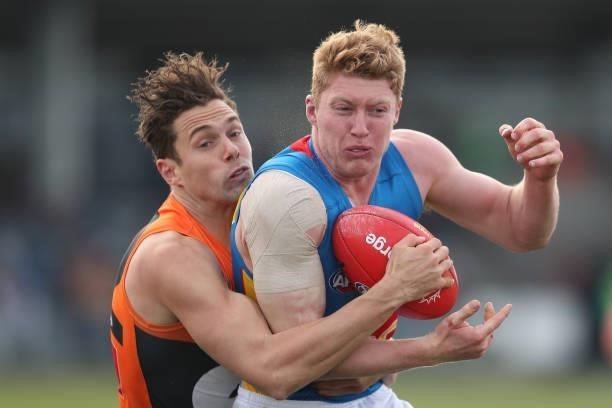 Matthew Rowell of the Suns is tackled during the round 17 AFL match between Greater Western Sydney Giants and Gold Coast Suns at Mars Stadium on July...