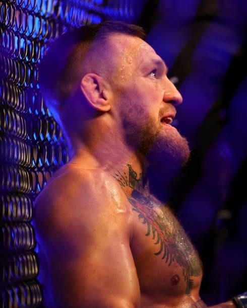 Conor McGregor of Ireland sits on the mat after injuring his ankle in the first round in his lightweight bout against Dustin Poirier during UFC 264:...