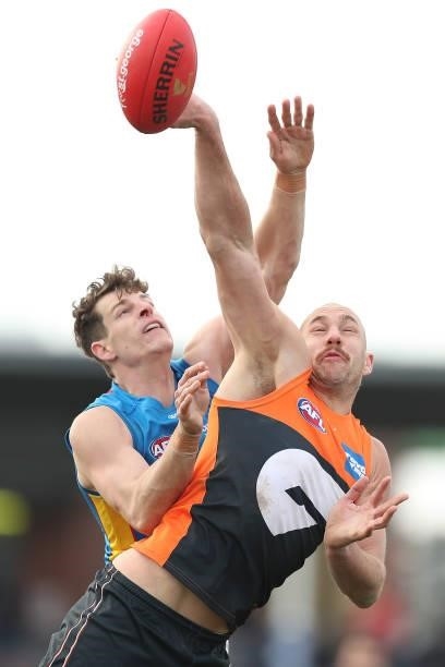 Chris Burgess of the Suns and Shane Mumford of the Giants compete for the ball during the round 17 AFL match between Greater Western Sydney Giants...