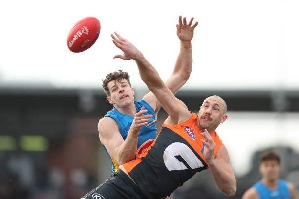 Chris Burgess of the Suns and Shane Mumford of the Giants compete for the ball during the round 17 AFL match between Greater Western Sydney Giants...