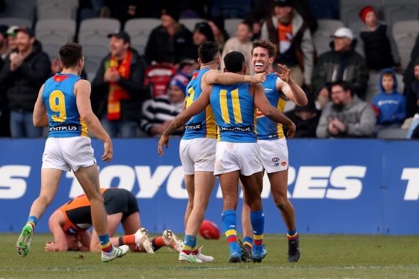 Suns players embrace after the final siren during the round 17 AFL match between Greater Western Sydney Giants and Gold Coast Suns at Mars Stadium on...