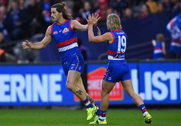 Josh Bruce of the Bulldogs is congratulated by team mates after kicking a goal during the round 17 AFL match between Western Bulldogs and Sydney...