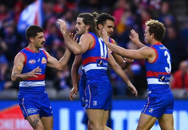 Josh Bruce of the Bulldogs is congratulated by team mates after kicking a goal during the round 17 AFL match between Western Bulldogs and Sydney...