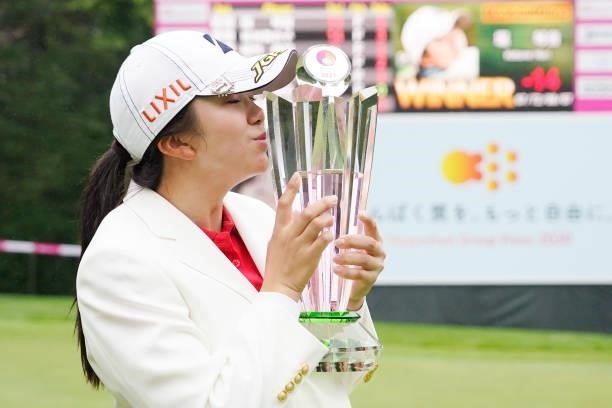 Kotone Hori of Japan kisses the trophy after winning the tournament following the final round of the Nipponham Ladies Classic at Katsura Golf Club on...