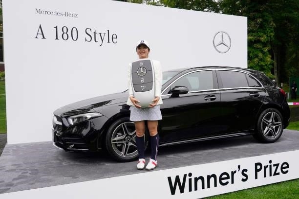 Kotone Hori of Japan poses with a prize car after winning the Nipponham Ladies Classic at Katsura Golf Club on July 11, 2021 in Tomakomai, Hokkaido,...