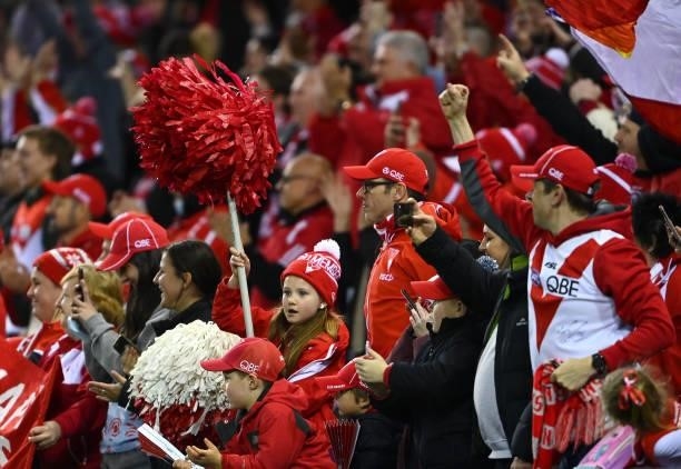 Swans fans celebrate during the round 17 AFL match between Western Bulldogs and Sydney Swans at Marvel Stadium on July 11, 2021 in Melbourne,...