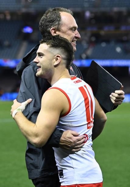 Swans head coach John Longmire hugs Tom Papley of the Swans after winning the round 17 AFL match between Western Bulldogs and Sydney Swans at Marvel...