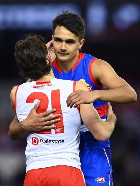Errol Gulden of the Swans and Jamarra Ugle-Hagan of the Bulldogs hug at the end of the match during the round 17 AFL match between Western Bulldogs...