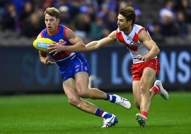 Mitch Hannan of the Bulldogs is tackled by Dane Rampe of the Swans during the round 17 AFL match between Western Bulldogs and Sydney Swans at Marvel...