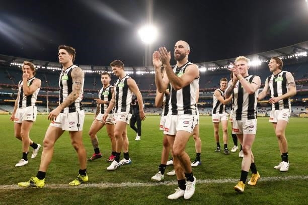 Steele Sidebottom of the Magpies and the Magpies celebrate victory during the round 17 AFL match between Richmond Tigers and Collingwood Magpies at...
