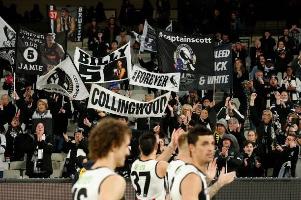 Collingwood fans cheer after the round 17 AFL match between Richmond Tigers and Collingwood Magpies at Melbourne Cricket Ground on July 11, 2021 in...