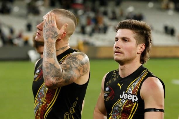 Dustin Martin and Liam Baker of the Tigers walk from the ground after during the round 17 AFL match between Richmond Tigers and Collingwood Magpies...