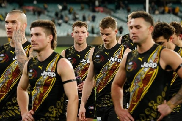 Dejected Richmond players walk from the ground after the round 17 AFL match between Richmond Tigers and Collingwood Magpies at Melbourne Cricket...
