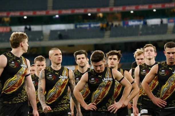 Dejected Richmond players walk from the ground after the round 17 AFL match between Richmond Tigers and Collingwood Magpies at Melbourne Cricket...