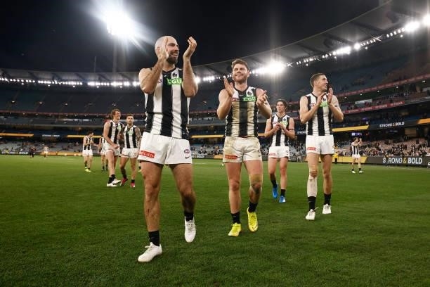 Steele Sidebottom of the Magpies, Taylor Adams of the Magpies and Darcy Cameron of the Magpies celebrate after victory in the round 17 AFL match...