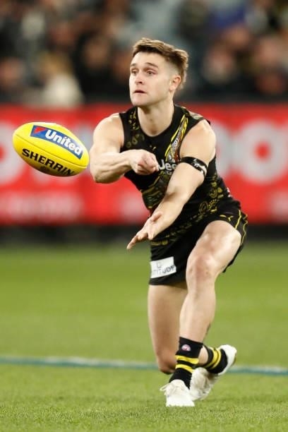 Jayden Short of the Tigers handballs during the round 17 AFL match between Richmond Tigers and Collingwood Magpies at Melbourne Cricket Ground on...