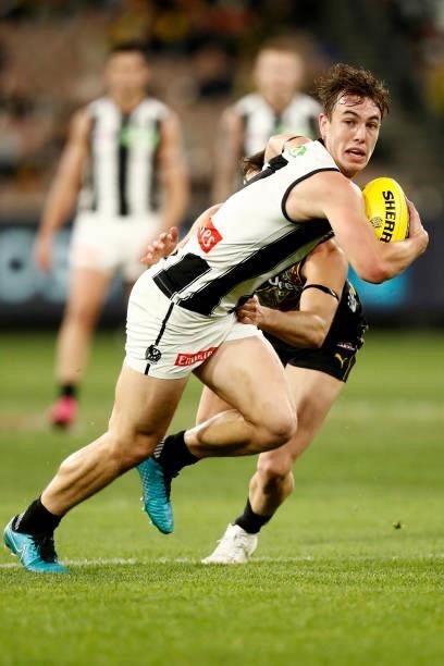 Callum L. Brown of the Magpies runs with the ball during the round 17 AFL match between Richmond Tigers and Collingwood Magpies at Melbourne Cricket...