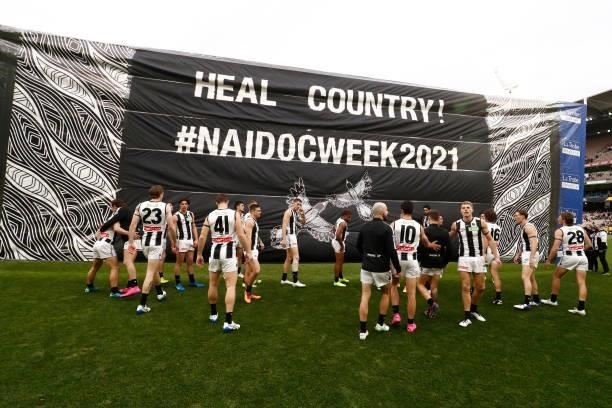 Collingwood players run out before the round 17 AFL match between Richmond Tigers and Collingwood Magpies at Melbourne Cricket Ground on July 11,...
