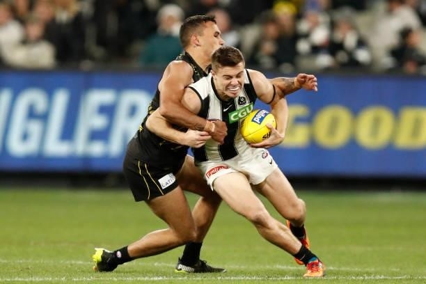 Sydney Stack of the Tigers tackles Josh Thomas of the Magpies during the round 17 AFL match between Richmond Tigers and Collingwood Magpies at...