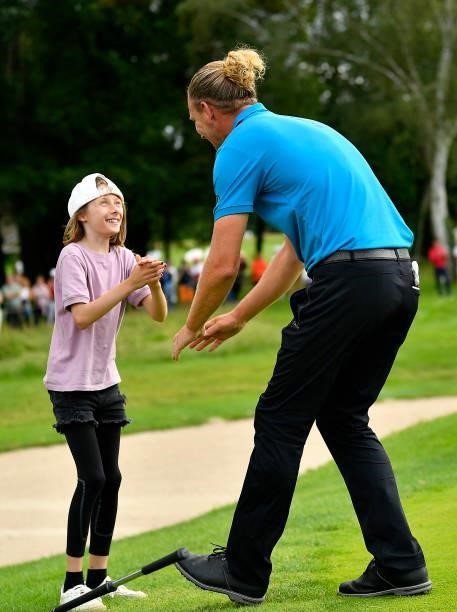 Marcel Siem of Germany celebrates with his daughter following victory in the Le Vaudreuil Golf Challenge at Golf PGA France du Vaudreuil on July 11,...