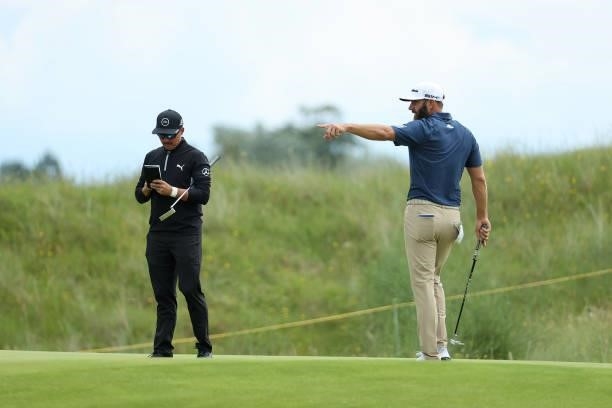 Rickie Fowler and Dustin Johnson of the United States speak during a practice round for The 149th Open at Royal St George’s Golf Club on July 11,...