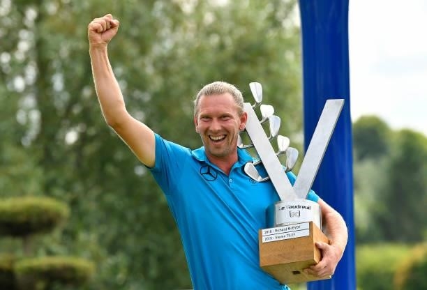 Marcel Siem of Germany celebrates with the trophy following victory in the Le Vaudreuil Golf Challenge at Golf PGA France du Vaudreuil on July 11,...