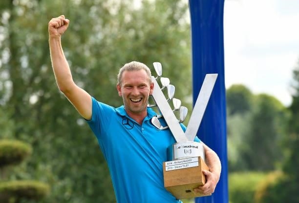 Marcel Siem of Germany celebrates with the trophy following victory in the Le Vaudreuil Golf Challenge at Golf PGA France du Vaudreuil on July 11,...