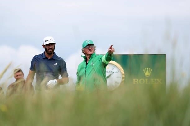 Marshall points out the line to Dustin Johnson of the United States during a practice round for The 149th Open at Royal St George’s Golf Club on July...