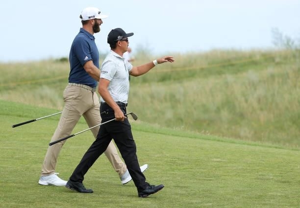 Rickie Fowler and Dustin Johnson of the United States speak during a practice round for The 149th Open at Royal St George’s Golf Club on July 11,...