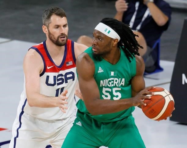 Precious Achiuwa of Nigeria is guarded by Kevin Love of the United States during an exhibition game at Michelob ULTRA Arena ahead of the Tokyo...
