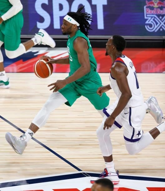 Precious Achiuwa of Nigeria brings the ball up the court against Bam Adebayo of the United States during an exhibition game at Michelob ULTRA Arena...