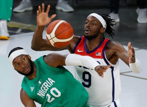 Josh Okogie of Nigeria and Jerami Grant of the United States fight for a rebound during an exhibition game at Michelob ULTRA Arena ahead of the Tokyo...
