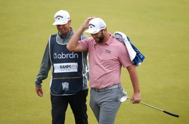 Jon Rahm of Spain and his caddie walk off the18th green during Day Four of the abrdn Scottish Open at The Renaissance Club on July 11, 2021 in North...