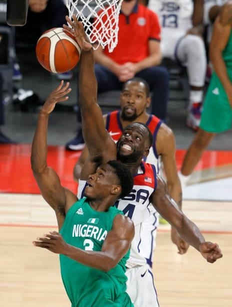 Draymond Green of the United States blocks a shot by Caleb Agada of Nigeria during an exhibition game at Michelob ULTRA Arena ahead of the Tokyo...