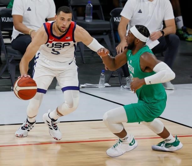 Zach LaVine of the United States is guarded by Josh Okogie of Nigeria during an exhibition game at Michelob ULTRA Arena ahead of the Tokyo Olympic...