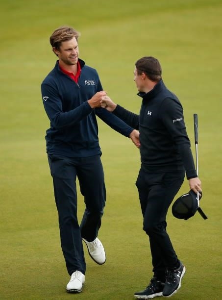Thomas Detry of Belgium shakes hands with Matthew Fitzpatrick of England on the 18th green during Day Four of the abrdn Scottish Open at The...
