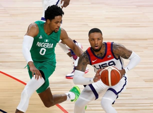 Damian Lillard of the United States passes against KZ Okpala of Nigeria during an exhibition game at Michelob ULTRA Arena ahead of the Tokyo Olympic...