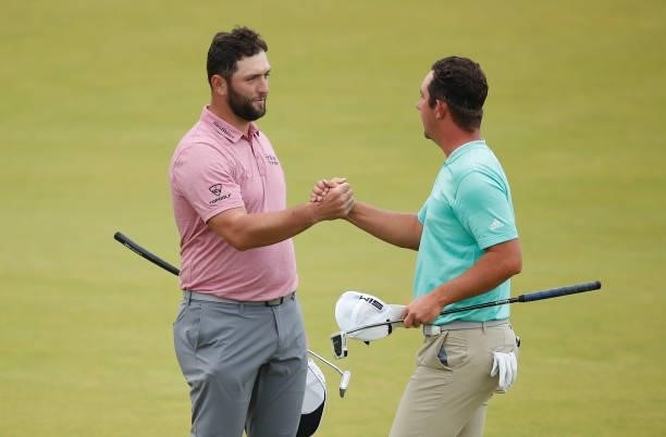 Jon Rahm of Spain shakes hands with Lucas Herbert of Australia on the 18th green during Day Four of the abrdn Scottish Open at The Renaissance Club...