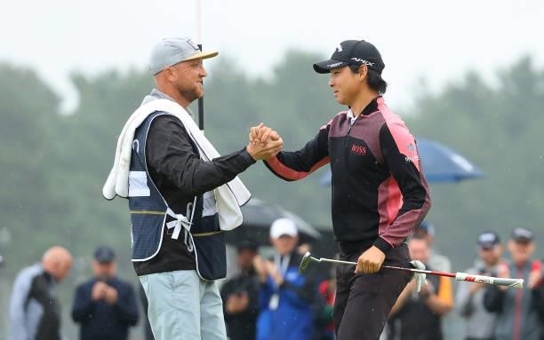 Min Woo Lee of Australia celebrates with his caddie after winning the abrdn Scottish Open at The Renaissance Club on July 11, 2021 in North Berwick,...