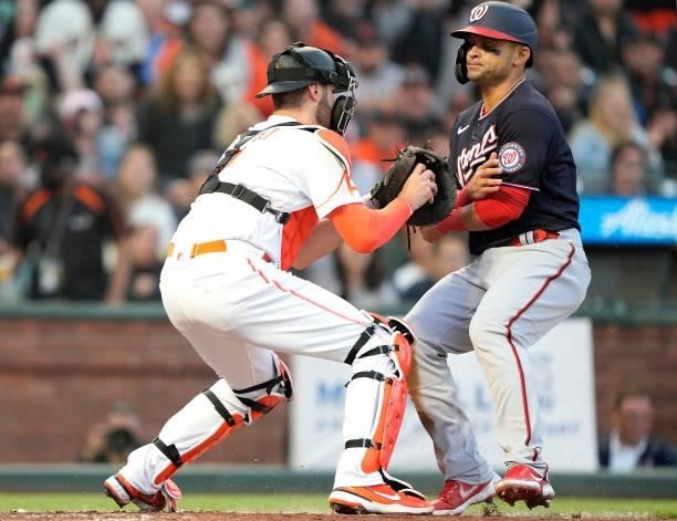 Curt Casali of the San Francisco Giants tags out Gerardo Parra of the Washington Nationals in the top of the fourth inning at Oracle Park on July 09,...