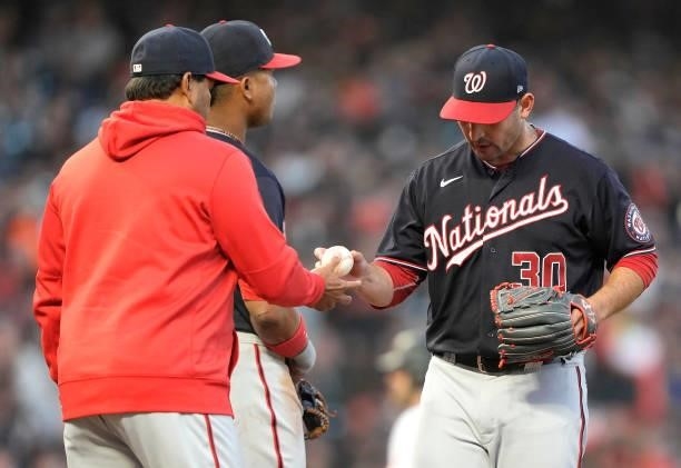 Manager Dave Martinez of the Washington Nationals takes the ball from starting pitcher Paolo Espino taking Espino out of the game against the San...