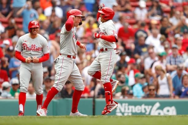 Ronald Torreyes of the Philadelphia Phillies celebrates with Brad Miller and Rhys Hoskins after hitting a three run home run against the Boston Red...