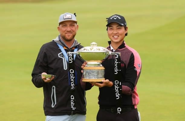 Min Woo Lee of Australia and caddie William Harke celebrate with the trophy after winning the abrdn Scottish Open at The Renaissance Club on July 11,...