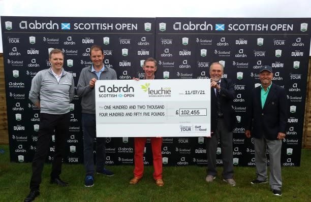 Charity cheque is presented during Day Four of the abrdn Scottish Open at The Renaissance Club on July 11, 2021 in North Berwick, Scotland.